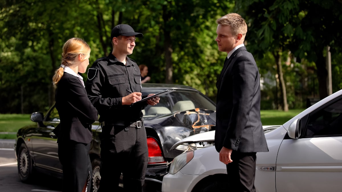 three people at a car accident scene