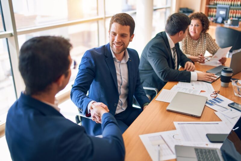 people at a business meeting shaking hands